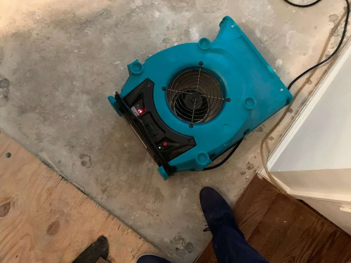 Air mover drying subfloor during Commercial Water Damage Restoration in Alachua